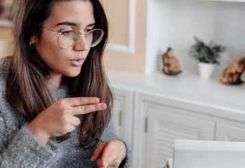 A woman uses American Sign Language in a video call.
