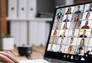 Closeup of someone in a video call with several other people.