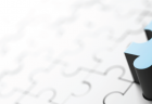 A blue puzzle piece poised to complete a puzzle.
