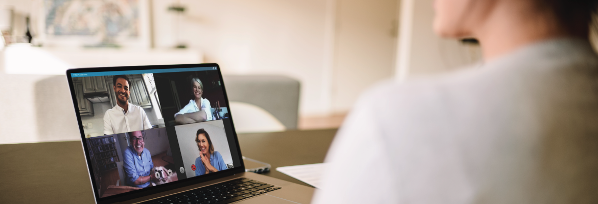 View over the shoulder of someone who is in a video call on a laptop.