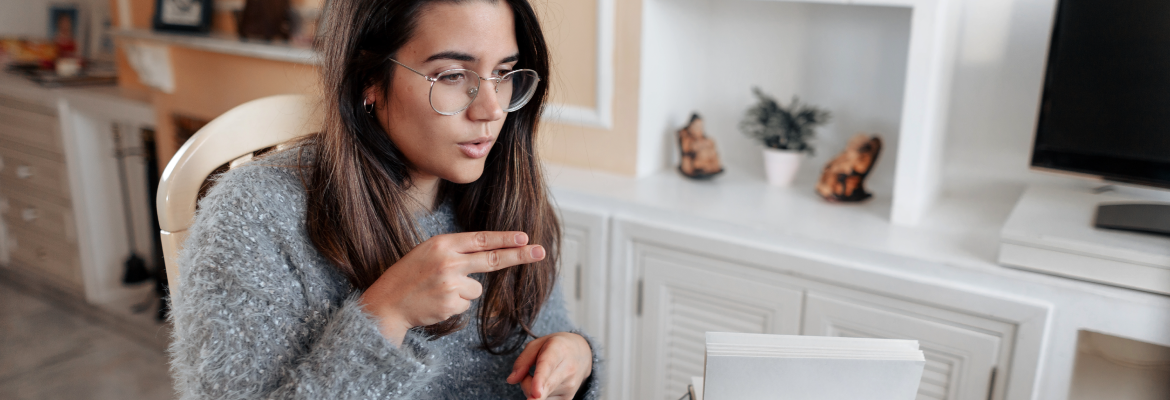 A woman uses American Sign Language in a video call.