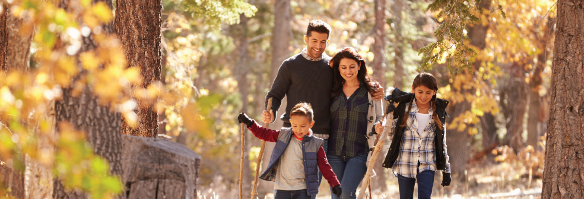 A family hiking in an autumn forest.