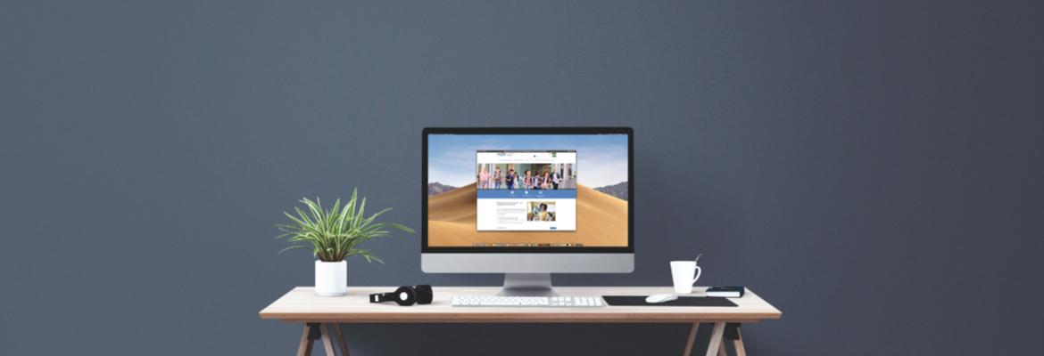 A desk with a computer displaying the MDE-LIO website