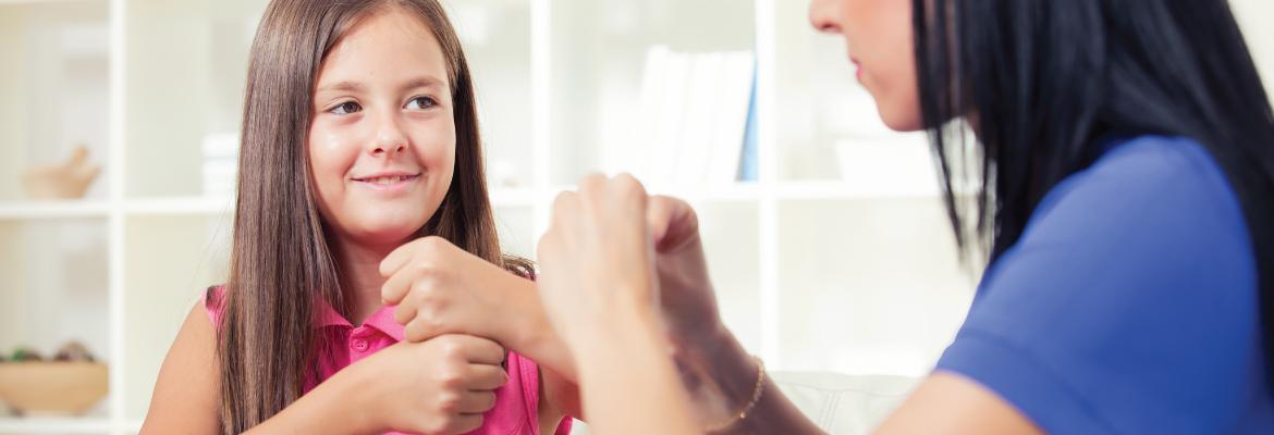 Female adult and female child speaking sign language