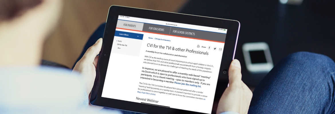 Closeup of someone reading about a cortical visual impairment training on the Perkins School for the Blind website.
