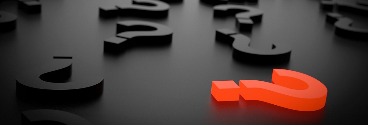 Illustration of a red question mark block surrounded by black question mark blocks resting on a dark surface.