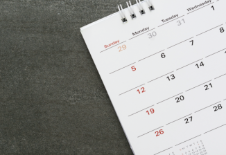 A calendar on a grey background. 