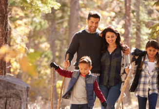 A family hiking in an autumn forest. 