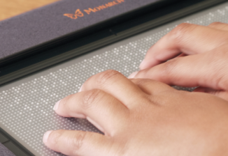 A childs hands on the Monarch tablet